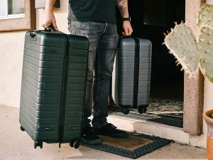man-holding-two-suitcases.jpg